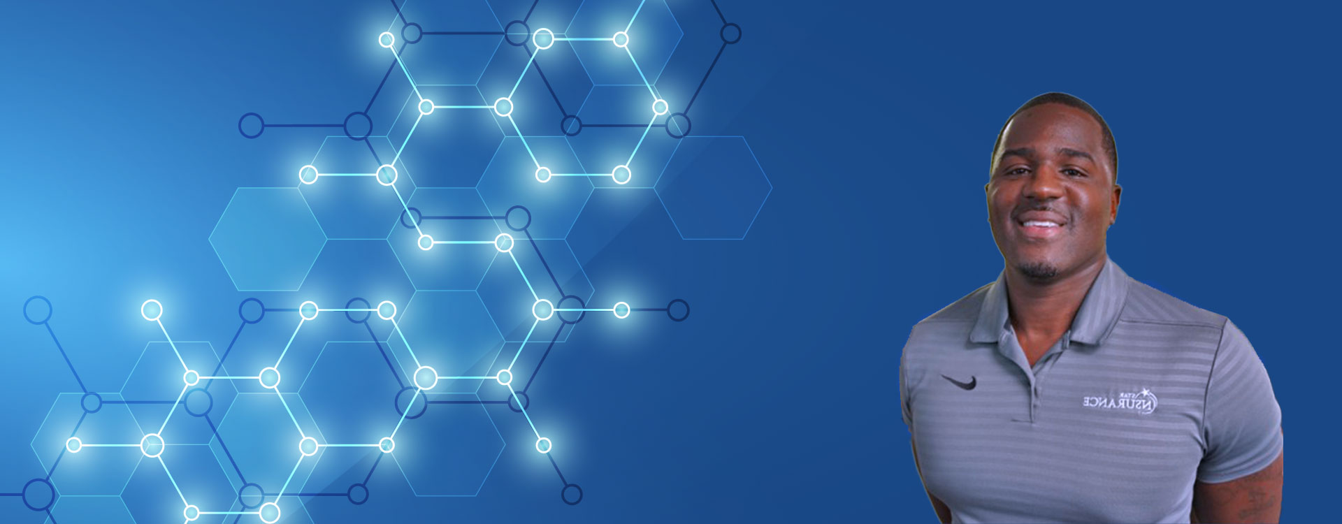 Byron Johnson in front of blue background